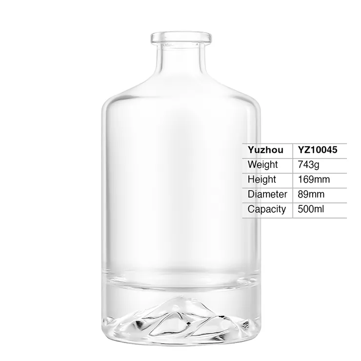 A crystal-clear $500\text{ml}$ round super flint glass spirit bottle with a thick base featuring an embossed mountain peak design inside, shown with technical specifications.